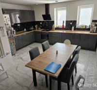 A kitchen in a family house with modern equipment and a large table for six people.
