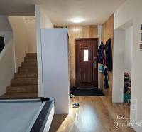 Entrance hall in a family house with wooden stairs and storage space.