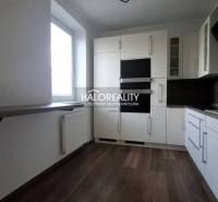 A kitchen in a 2-room apartment with modern equipment, including a white kitchen unit and appliances.
