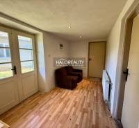 Interior in a family house with wooden flooring and a brown armchair.