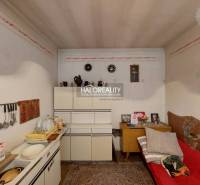 A room in a family house with storage cabinets, a sink, and simple decor.
