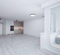 Bright kitchen in a 3-room apartment with flooring and built-in appliances.