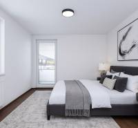 Bright bedroom in a 3-room apartment with a large bed, nightstands, and modern art.