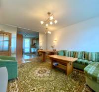 Living room with a comfortable sofa and a dining table in a 3-room apartment.