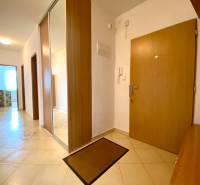 A hallway with ceramic tiles and a built-in wardrobe in a 3-room apartment.