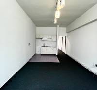 Commercial premises with a kitchen unit and pendant lights.