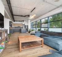 Living room in a 4-room apartment with a large sofa and a wooden table.