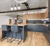 A kitchen in a 4-room apartment with stylish chairs and wooden furniture.