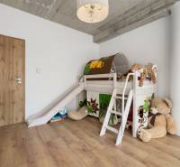 A children's room with a slide and plush toys in a 4-room apartment.