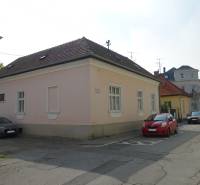 A family house on Hviezdoslavova Street in Piešťany. Pink plaster, cars parked next to it.