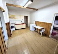 Simple kitchen with wooden paneling in a family house.