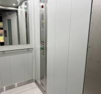 The interior of an elevator in a one-room apartment, with touch control panels and a mirror.