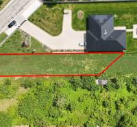 A plot for residential use in Nové Mesto nad Váhom next to the road, bordered by a red line.