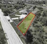 A plot for residential use with two roads and vegetation in Nové Mesto nad Váhom.