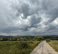 Landscape with clouds and a country road in Ľubotín, ideal for commercial land.