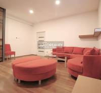 Living room, red corner sofa, mirrored wardrobe, round table, ideal for a family house.