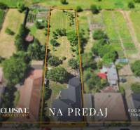 Aerial view of a land sale with a family house in Tvrdošovce, set in greenery.
