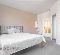 Bedroom with a comfortable bed and a water heater in a family house.