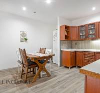 Kitchen with a table and wooden cabinets in a family house.