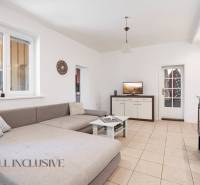 Living room in a family house with a gray sofa, table, and fireplace.