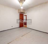 A view of an empty room with doors in a 3-room apartment, ready for renovation.
