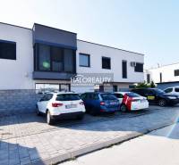 A family house in Rovinka with parking and a modern facade, surrounded by cars.