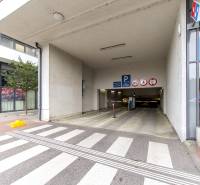 Underground parking on Kaštieľska Street in Bratislava, near a 3-room apartment, entrance and signage.