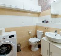 Bathroom in a 3-room apartment with a sink, washing machine, and toilet.