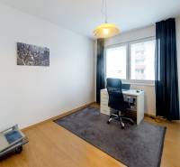 A study room in a 3-room apartment with a desk, a chair, and a decorative painting.