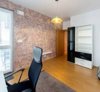 Office in a 3-room apartment with a window, shelving cabinet, and office chair.