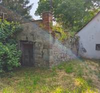 Old stone wall with a small door by the family house in Hont.