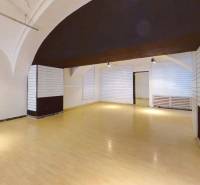 Spacious commercial premises with wooden flooring and white walls.