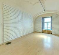 Interior of commercial spaces with wooden flooring and wall moldings.