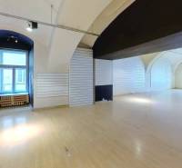 A large open space with vaulted ceilings and slatted wall paneling.