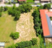 Building plot in Kynceľové Kračany in Dunajská Streda, surrounded by greenery and development.