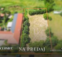 A plot of land in Kynceľové Kračany for sale, surrounded by greenery and properties.