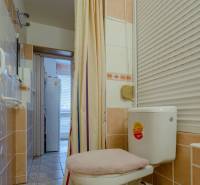 Bathroom with a shower curtain and a toilet in a 2-room apartment.