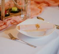 A table set with a plate, cutlery, and decorative elements in a dining area.