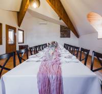 A table in interior dining spaces with prepared decorations and cutlery.