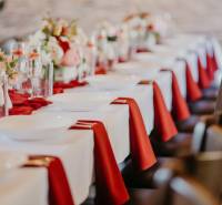 The tables in the dining area are elegantly set with white tablecloths and flowers.