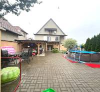 A family house in Veľké Chlievany with a garden, swimming pool, and a terrace with outdoor seating.