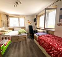 Children's room in a family house with two beds and a desk.