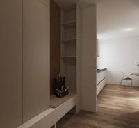 Cozy interior of a studio apartment with wooden flooring and a dining nook.