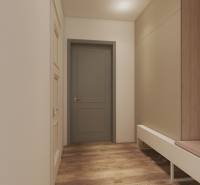 A hallway in a one-room apartment with a cabinet, a bench, and wooden details.