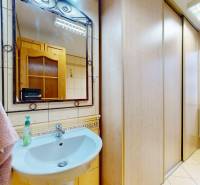 Bathroom with a sink, mirror, towel, and a view to the exterior in commercial premises.