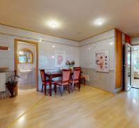Commercial space with wooden furniture, white walls, a sofa, and a sink.