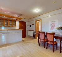 Interior with a kitchen unit, dining table, and decorative elements in commercial spaces.