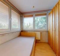 Interior with a bed, large wardrobe, and windows with a view, commercial spaces.