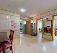 Commercial premises with flowers, a mirror, floating floor, and wooden furniture in the interior.