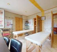 Beauty salon with massage tables, decorations, and paintings. Commercial premises.